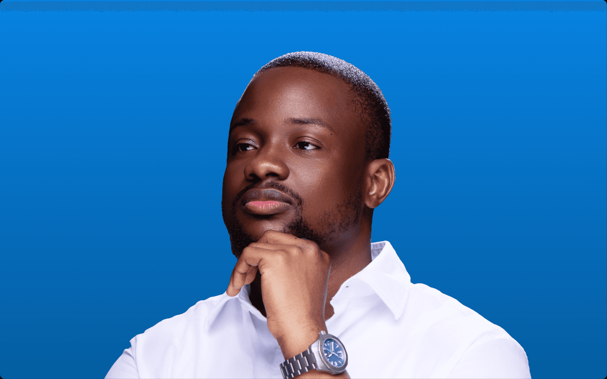 Portrait of Dr. Wahab Disu in a white shirt against an electric blue background